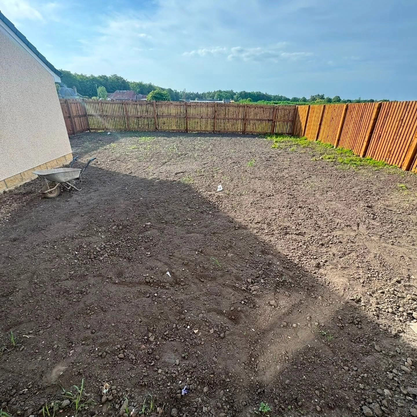 Bare, rutted ground in a Whitecraig back garden before new turf was laid