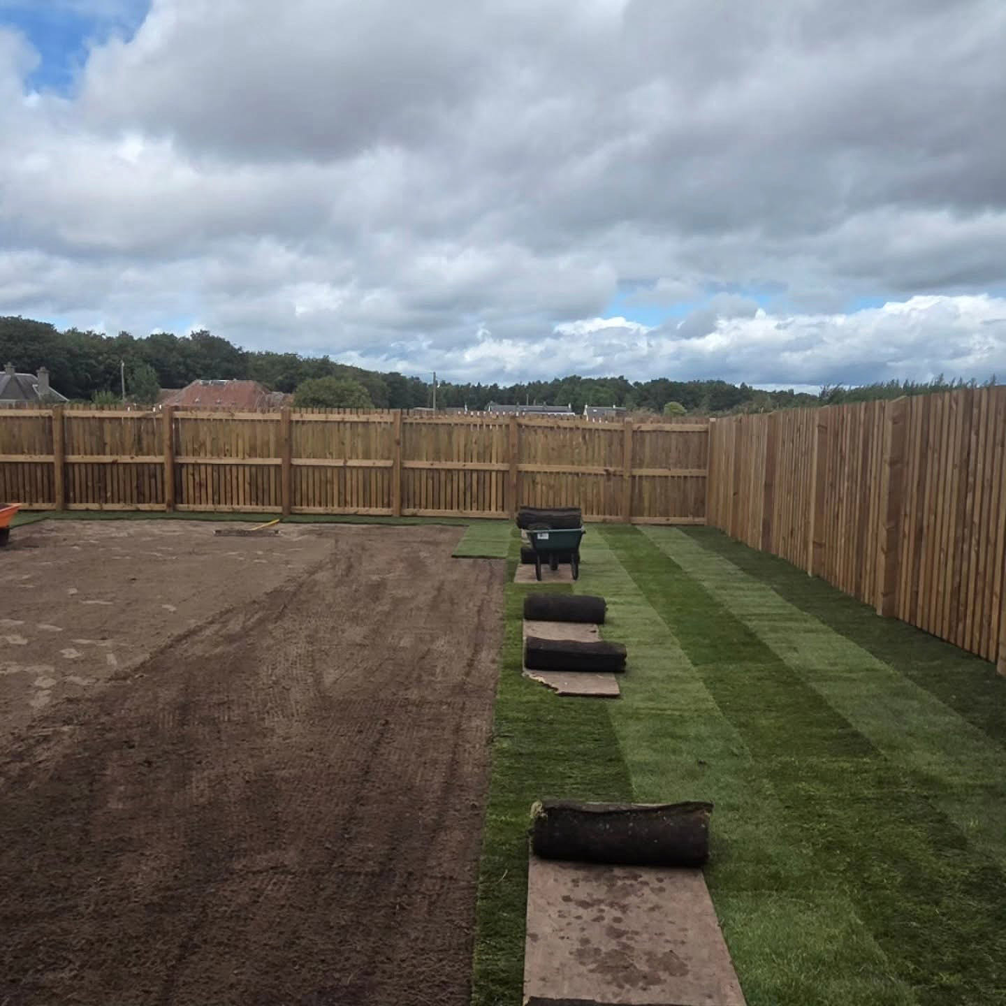 First rows of new turf going down in a Whitecraig garden