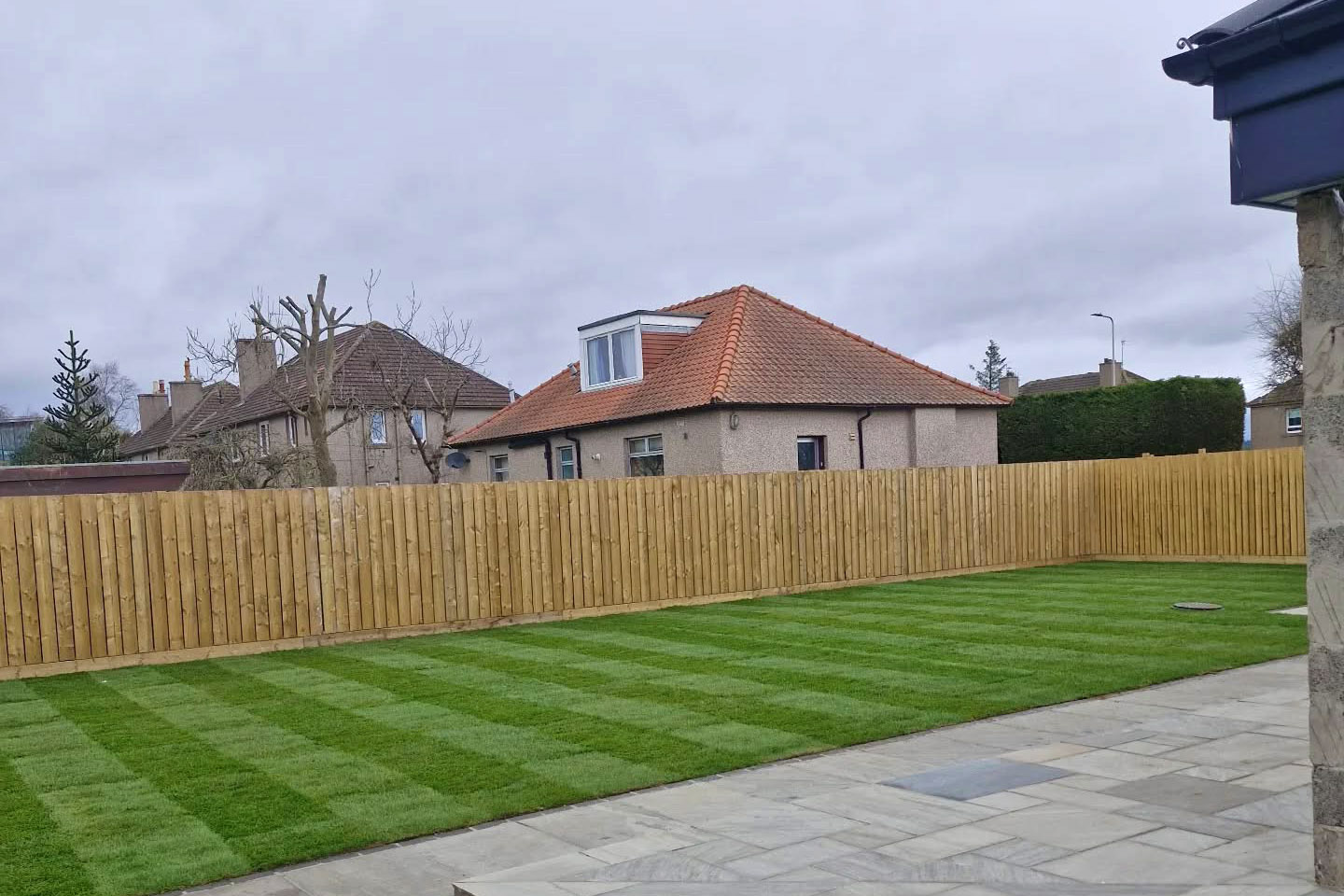 Restored back garden lawn with mowing stripes